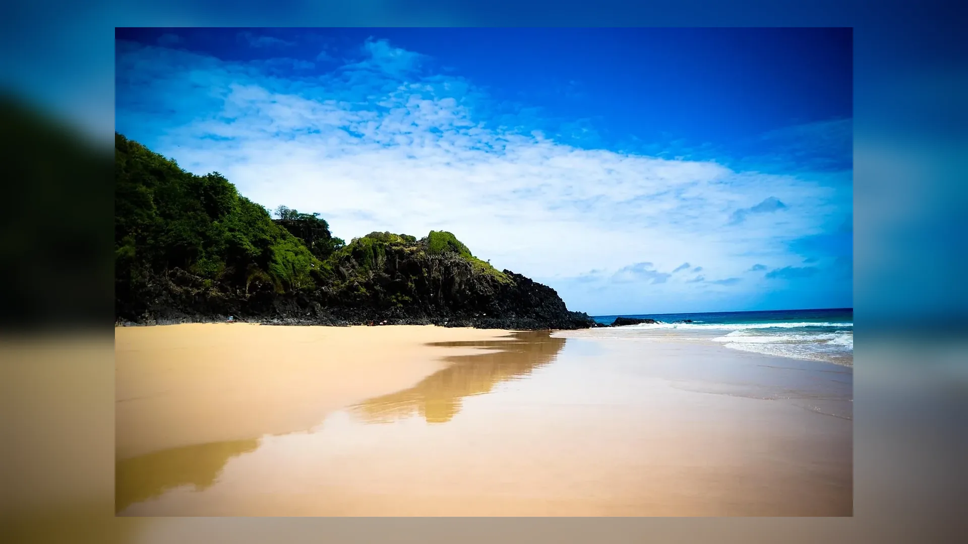 Hero image for the Corporate page showing Baia do Sancho in Fernando de Noronha at golden hour in Brazil.